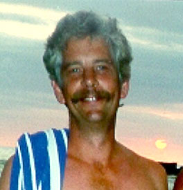 head photo of Kevin W. Krywe with blue and white stiped towel over right shoulder; sunset in background